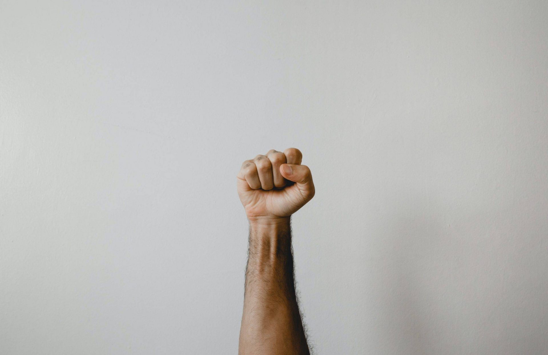 persons right foot on white wall